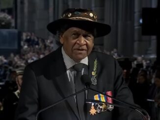 Man wearing hat and medals at podium
