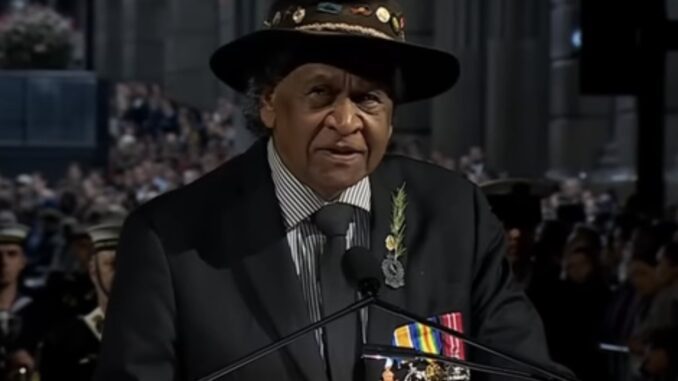 Man wearing hat and medals at podium