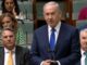 Male politician speaking at parliamentary podium