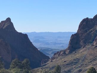 Desert mountain canyon with distant blue ridges
