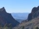 Desert mountain canyon with distant blue ridges