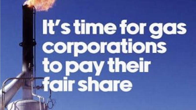Gas flare with message demanding corporate fair share Gas flare with message demanding corporate fair share