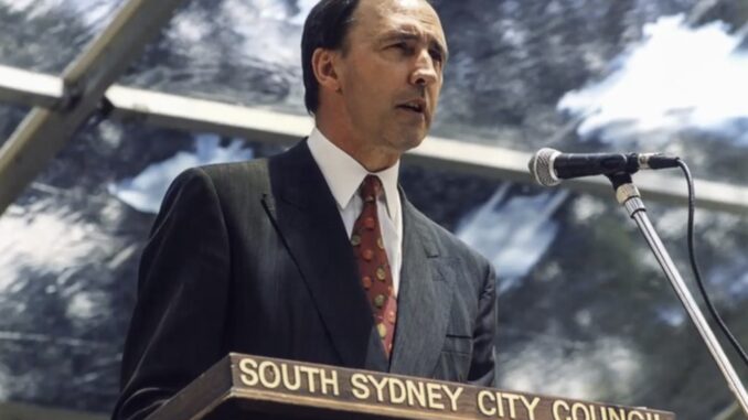 Man speaking at South Sydney City Council podium Man speaking at South Sydney City Council podium