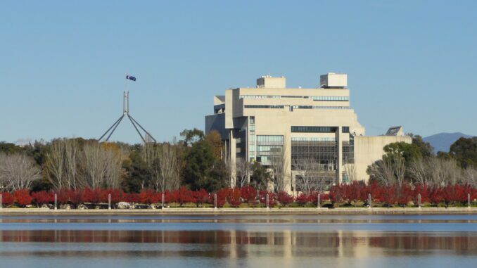 Government building and flag reflected in lake Government building and flag reflected in lake