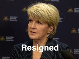 Woman at podium with "Resigned" overlay