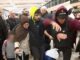 Group moving through crowded airport terminal