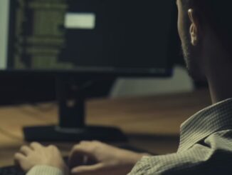 Person coding at computer workstation