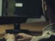 Person coding at computer workstation