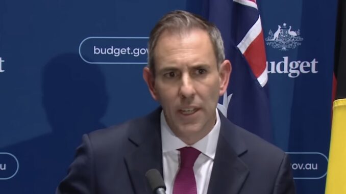 Man in suit speaking at government press conference Man in suit speaking at government press conference