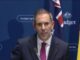 Man in suit speaking at government press conference