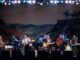 Live band performing on stage with guitars