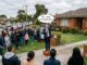 House auctioneer addressing crowd outside home