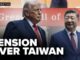 Two suited leaders beneath "Tension Over Taiwan" banner