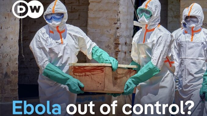 Healthcare workers in hazmat suits carrying coffin Healthcare workers in hazmat suits carrying coffin
