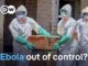 Healthcare workers in hazmat suits carrying coffin