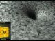 Dollar bills swirling into vortex, radioactive barrels inset