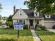 House with sign: "If you can afford it