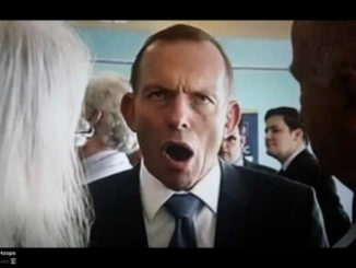 Man in suit shouting amid crowd