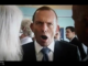 Man in suit shouting amid crowd