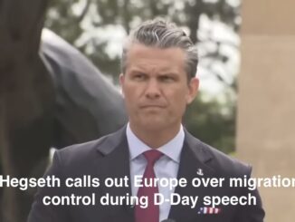 Man in suit giving speech outdoors