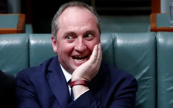 Man in suit laughing with hand on cheek Man in suit laughing with hand on cheek