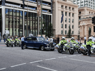 Motorcade with vintage car escorted by police motorcycles