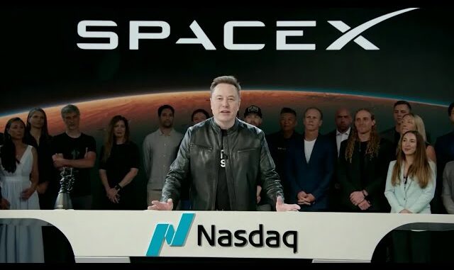 Person at Nasdaq podium with SpaceX logo