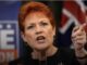 Red-haired woman pointing and speaking passionately