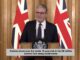 Speaker at podium with UK flags