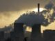 Power plant cooling towers emitting steam at sunset
