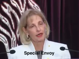 Woman speaking at podium captioned "Special Envoy