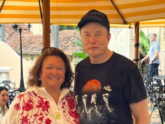 Man in hat and t-shirt with smiling woman