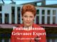 Red-haired woman speaking in front of parliament building