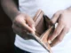 Hands holding empty leather wallet