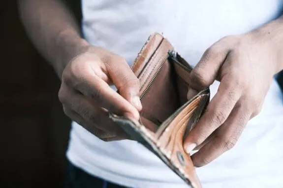 Hands holding empty leather wallet