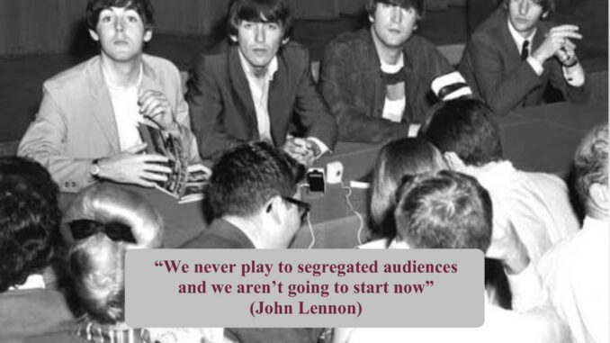 Four musicians at press conference with quote