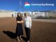 Two women outside Australian Parliament House, logo