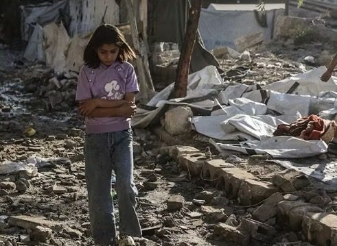Girl walking through rubble in makeshift camp Girl walking through rubble in makeshift camp