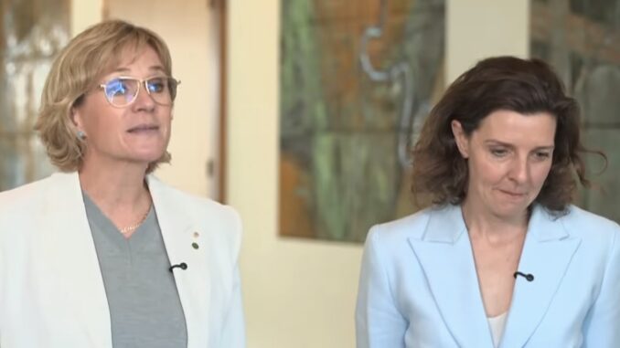 Two women in blazers with lapel microphones