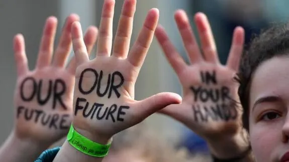 Raised hands with "Our Future" protest message Raised hands with "Our Future" protest message