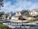 Row of suburban houses with parked cars