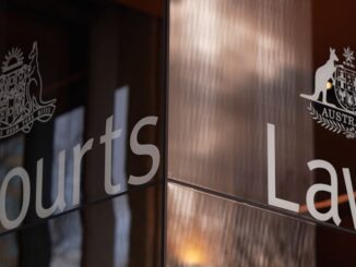 Glass entrance of Australian courthouse with emblem