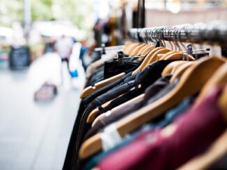 Clothes on hangers at outdoor market