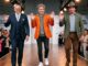 Three men waving on fashion runway