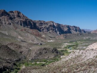 Arid canyon valley with river and cliffs