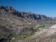 Arid canyon valley with river and cliffs