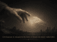 Aged hand reaching glowing child's hand above city